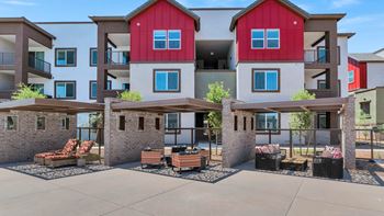 an outdoor patio with furniture in front of an apartment buildingat Weylyn Luxury Apartments, Laveen, AZ 85339